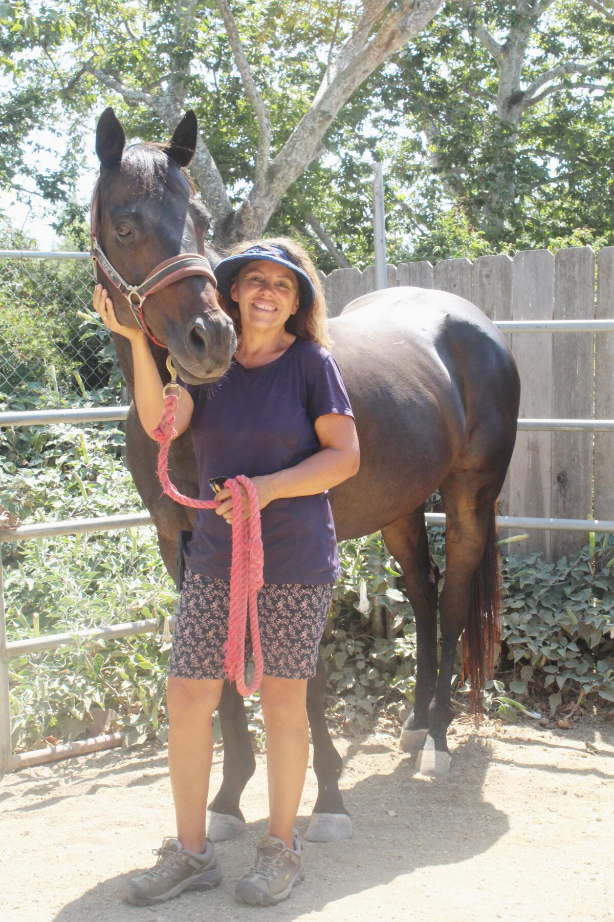 Huufprints Riding Therapy & Rescue Stables owner Tammie Joyce with one of her horses.