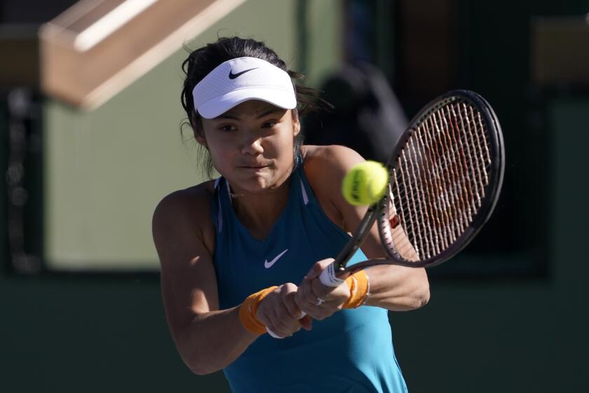 Emma Raducanu, of Britain, returns a shot against Caroline Garcia, of France, at the BNP Paribas Open tennis tournament Friday, March 11, 2022, in Indian Wells, Calif. (AP Photo/Mark J. Terrill)