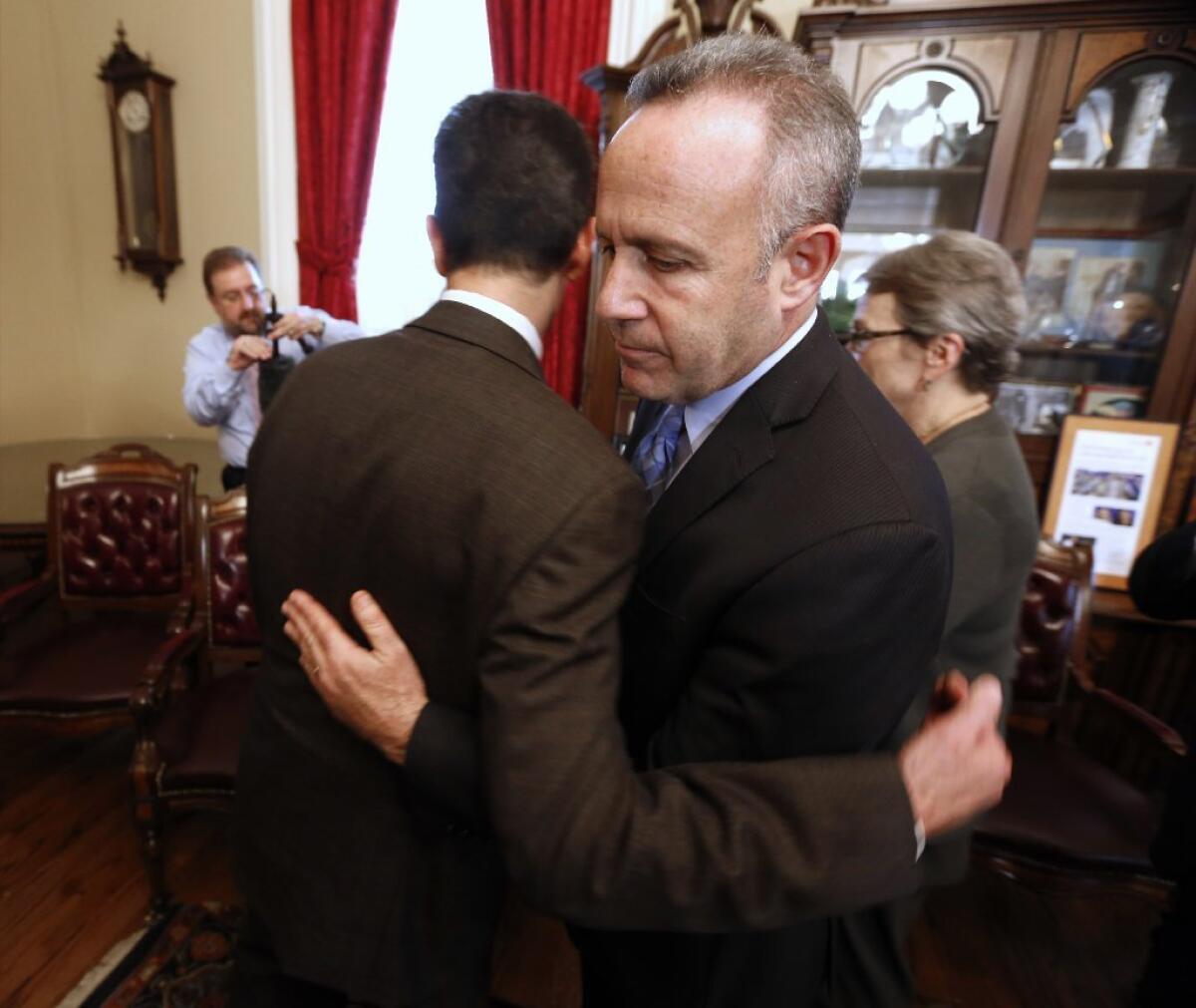 State Senate President Pro Tem Darrell Steinberg (D-Sacramento), right, is consoled by Sen. Mark Leno (D-San Francisco) after he and fellow Democrats on Wednesday called on Sen. Leland Yee (D-San Francisco) to resign in the wake of his arrest on federal corruption and firearm charges.