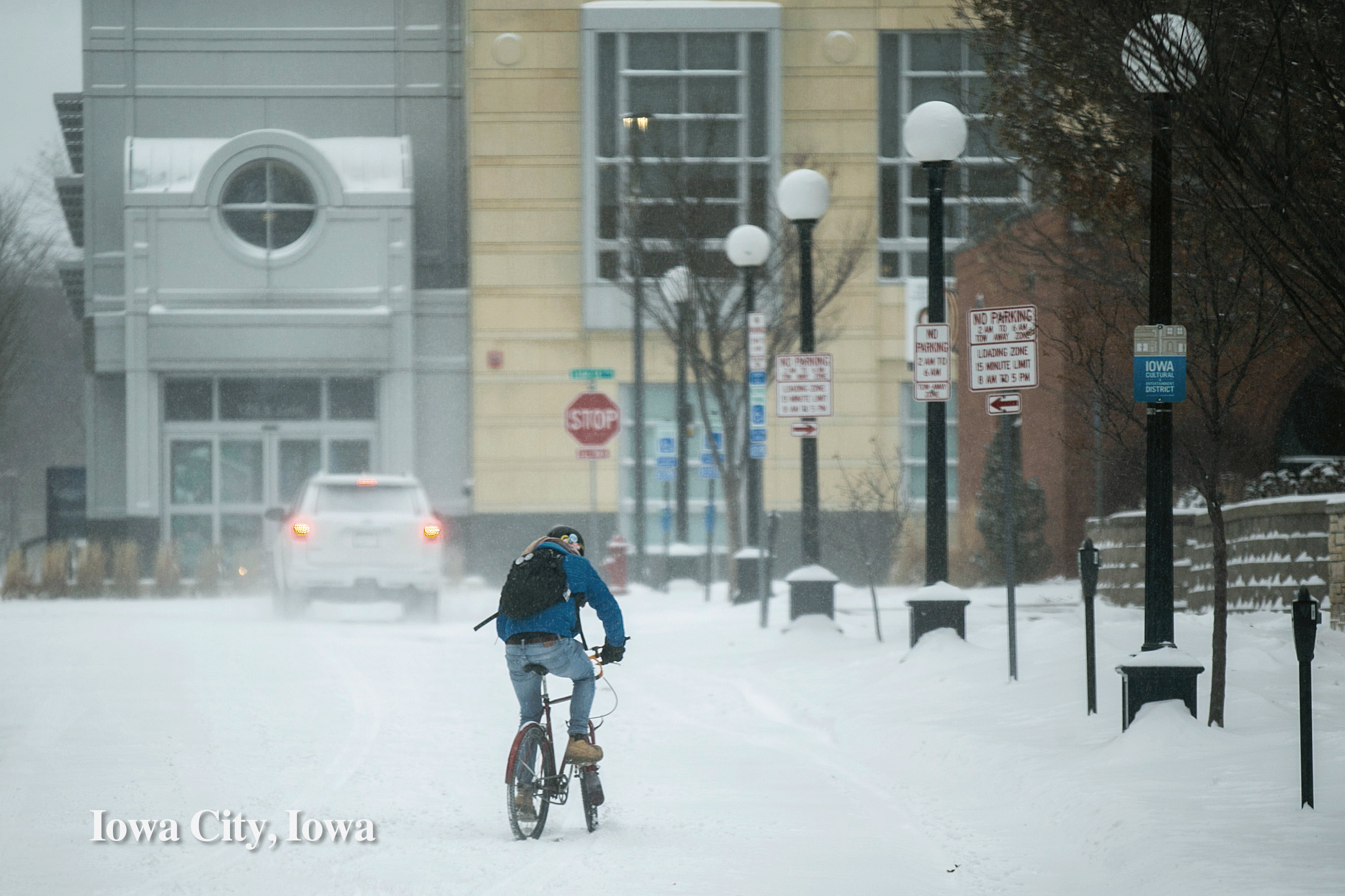Snowy street in Iowa City, Iowa and cyclists riding around Shoreline Aquatic Park in Long Beach