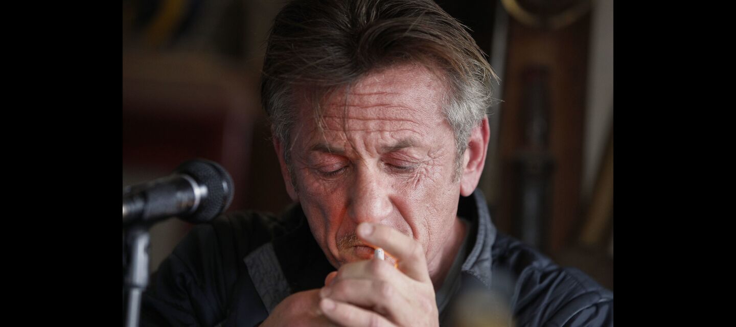 Sean Penn lights up a second cigarette after reading from his book 'Bob Honey Who Just Do Stuff'.