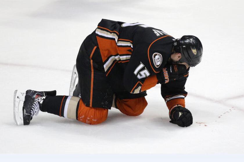 The Ducks' Ryan Getzlaf bleeds after he was hit in the face by a puck Wednesday against Dallas.