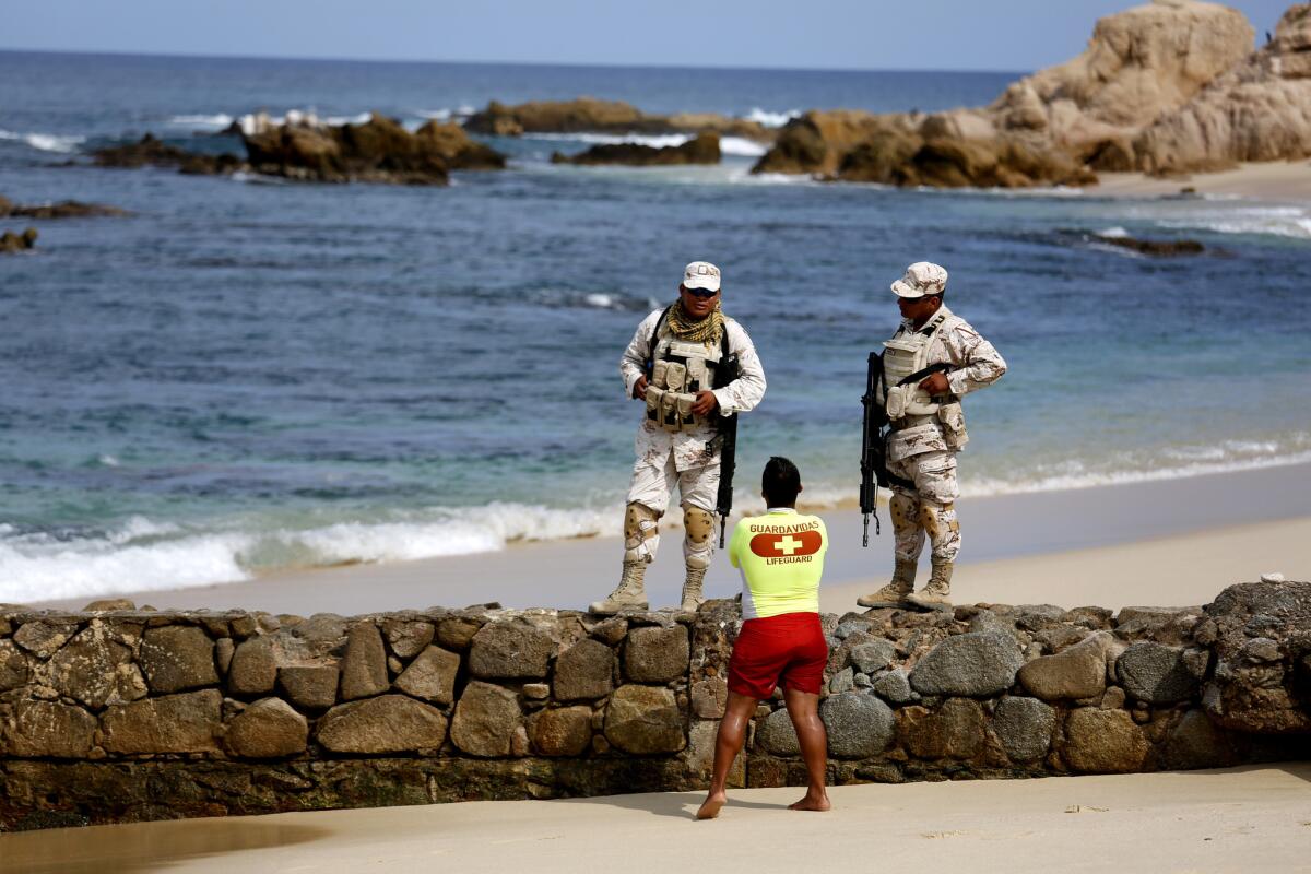 The Mexican Army patrols Palmilla Beach where recently three men were killed by a group of men with automatic weapons in San Jose del Cabo.