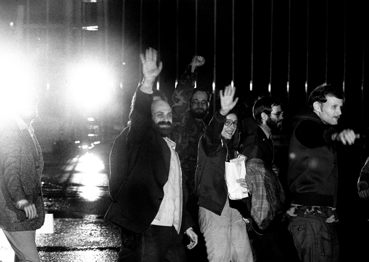 Barry Rosen, left, and other U.S. hostages wave to media as they arrive at Algiers airport from Tehran on Jan. 21, 1981.