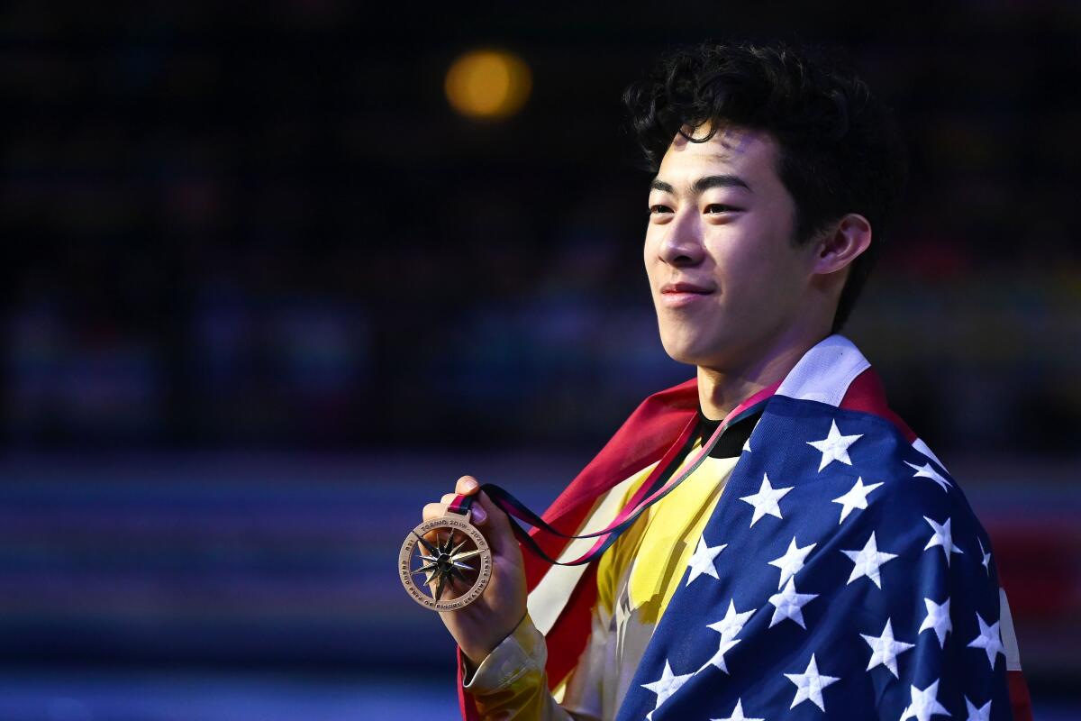 Nathan Chen poses with his medal after winning the men's free skate at the ISU Grand Prix of Figure Skating on Dec. 7 in Turin, Italy.