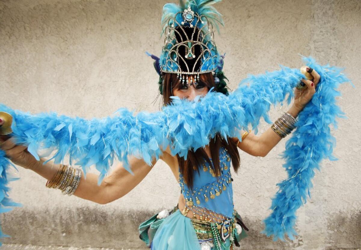 Nancy Urbach, also known as Queen Narayana, practices her belly dancing moves at her Pasadena home in November 2014 on the eve of her role as queen of last year's Pasadena Doo Dah Parade.