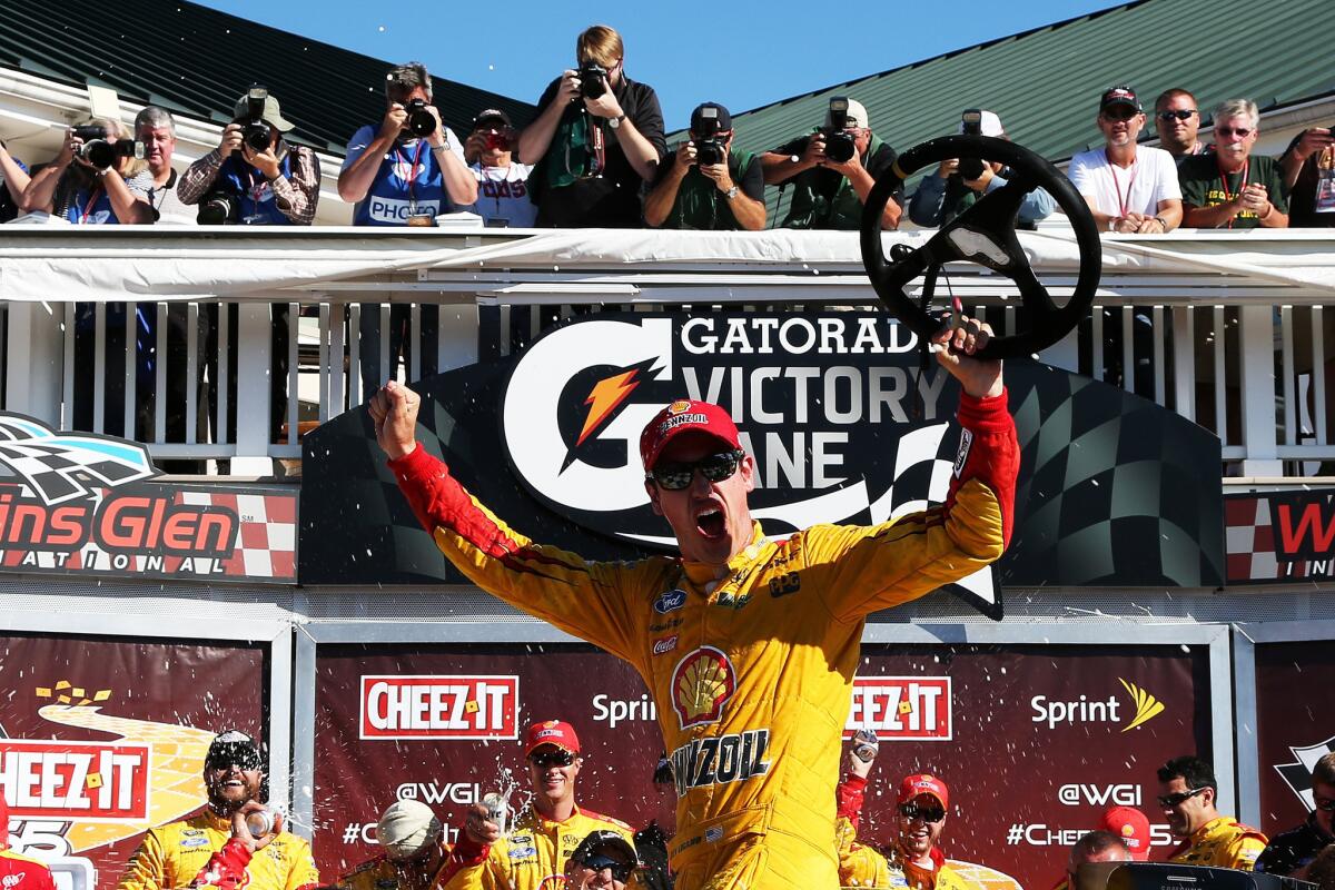 NASCAR driver Joey Logano, celebrates in Victory Lane after winning the Sprint Cup Series Cheez-It 355 at the Glen at Watkins Glen International on Sunday.