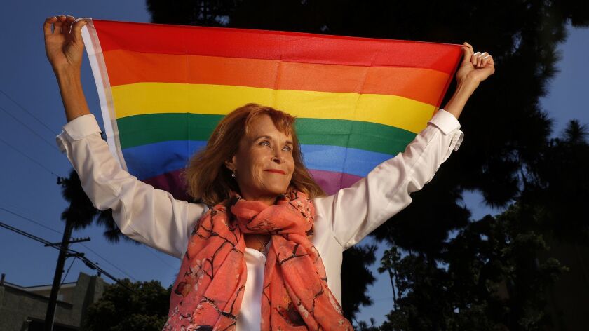 Lynn Segerblom, one of the women behind the creation of the first rainbow flags for the 1978 Gay Freedom Day Parade in San Francisco, is photographed with a rainbow flag near her home in Torrance.