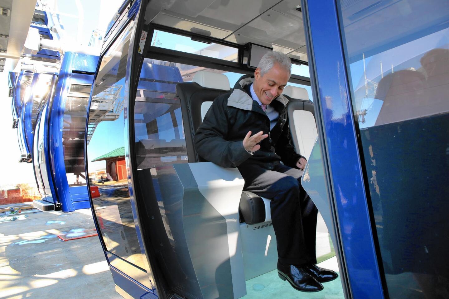 Chicago Mayor Rahm Emanuel tries out a new gondola on the Ferris wheel, slated to debut May 27 on Navy Pier.