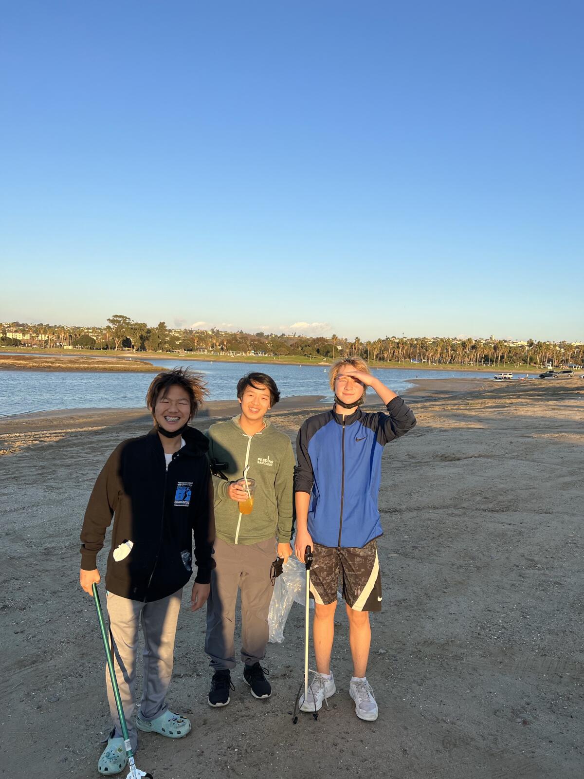 ForSocialGoods Club members Christopher Kam, Arthur Wang and Gavin Wendt at a beach clean-up at Mission Bay.
