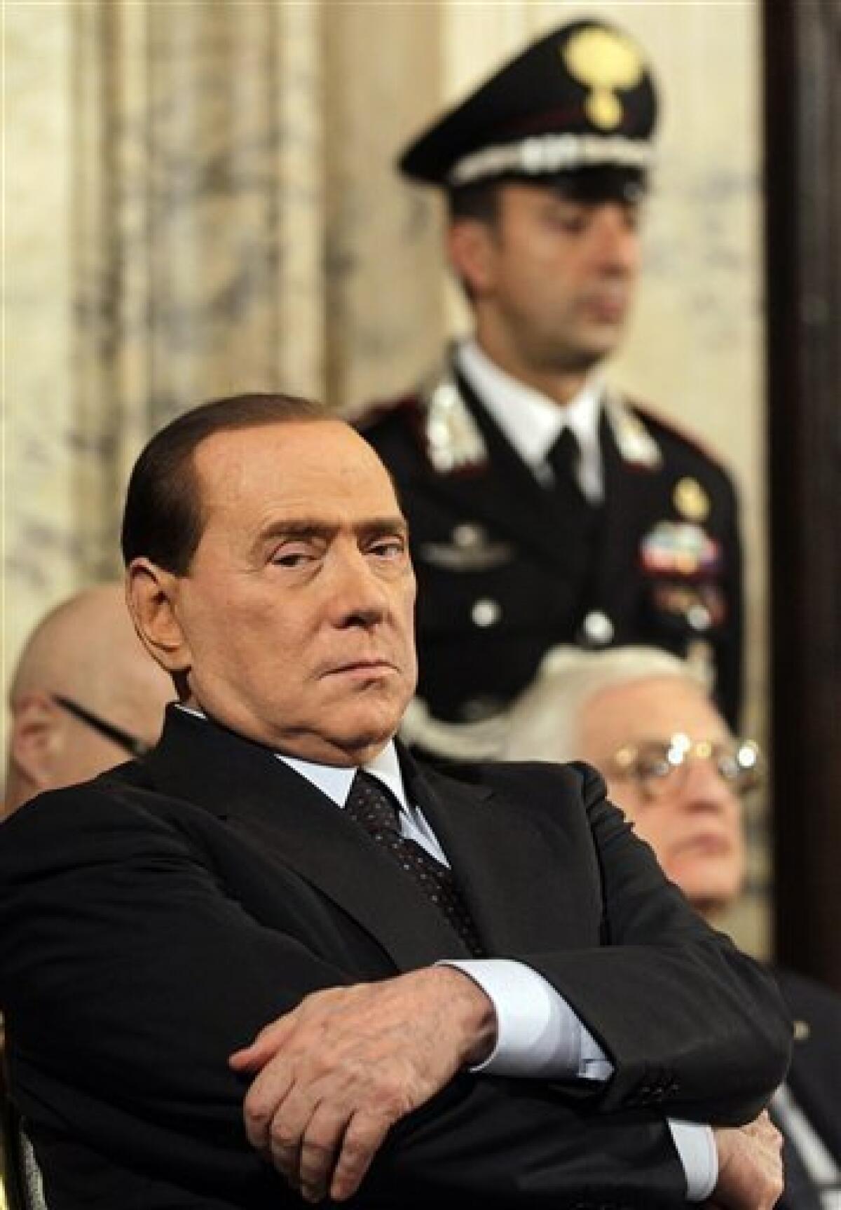 FILE - In this Monday, Dec. 20, 2010 file photo, Italian premier Silvio Berlusconi sits as he listen to a speech during the traditional meeting at the Quirinale Presidential palace called to exchange Christmas greetings in Rome. Italy's leading newspaper is reporting that Premier Silvio Berlusconi is under investigation in a prostitution case involving a then-17-year-old Moroccan girl. Corriere della Sera reported online Friday, Jan. 14, 2011, that the 74-year-old premier is suspected of abusing his power in trying to cover up his alleged encounters with the girl, nicknamed Ruby. Berlusconi's office said it had no immediate comment. (AP Photo/Alessandra Tarantino, File)