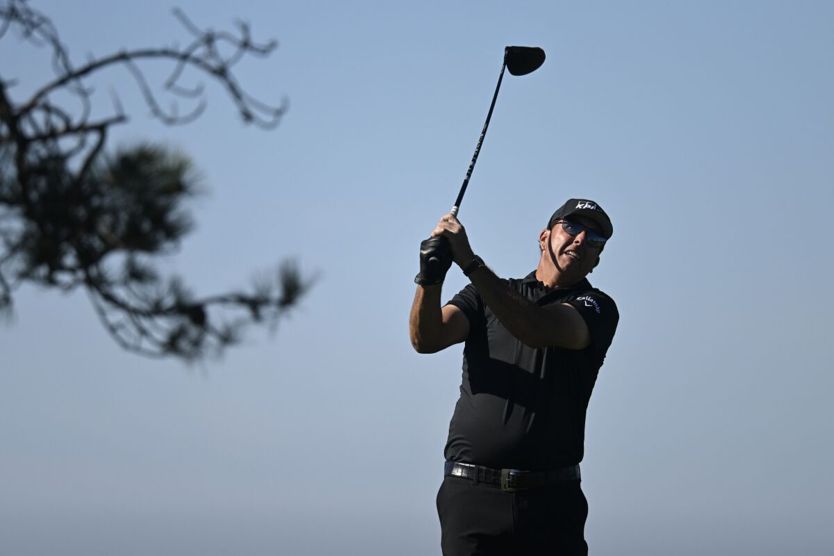 Phil Mickelson hits his tee shot on the 11th hole during the second round of the Farmers Insurance Open golf tournament, Thursday Jan. 27, 2022, in San Diego. (AP Photo/Denis Poroy)