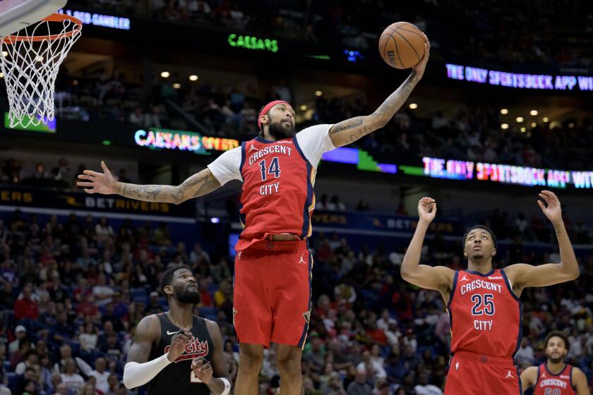 New Orleans Pelicans forward Brandon Ingram (14) grabs a rebound next to Portland Trail Blazers center Deandre Ayton during the second half of an NBA basketball game in New Orleans, Saturday, March 16, 2024. (AP Photo/Matthew Hinton)