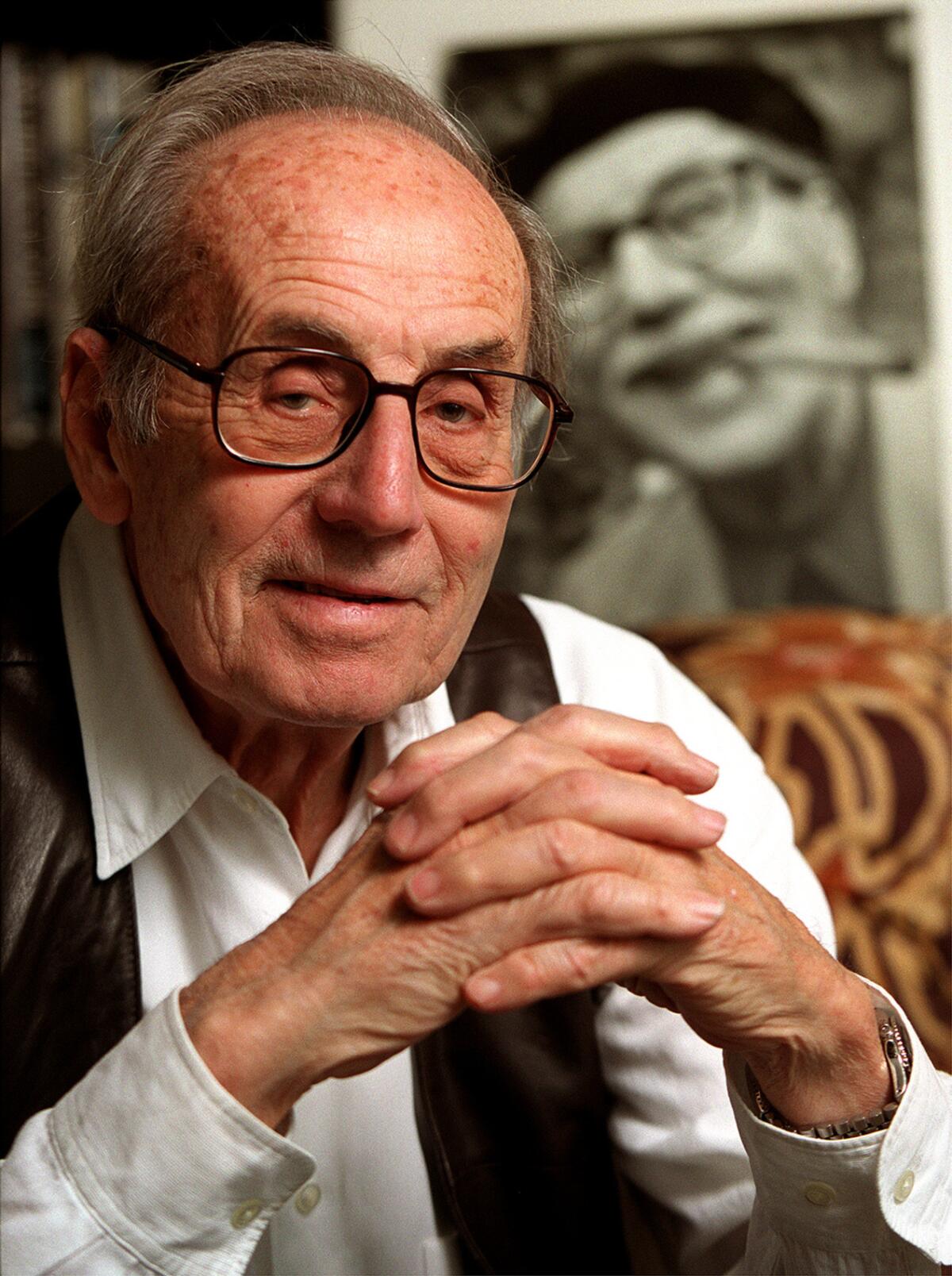 Arthur Marx in 2000, with photo of his father Groucho in background.