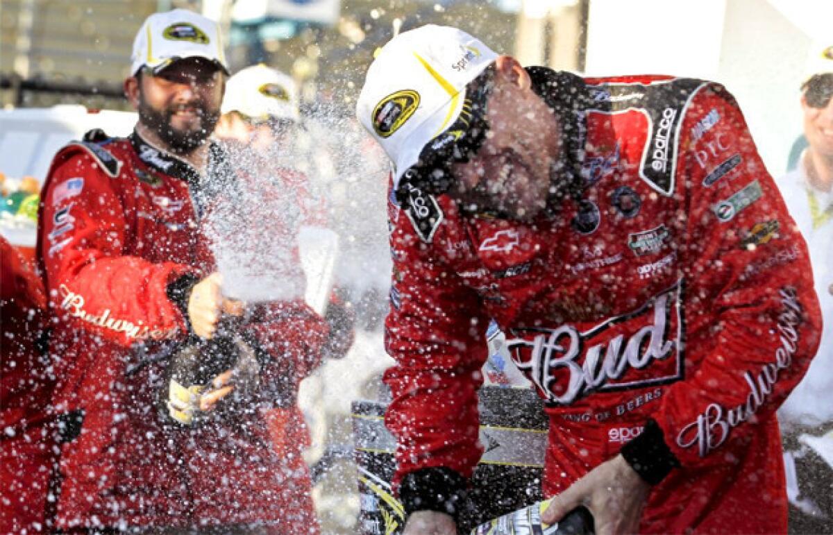 Kevin Harvick celebrates in victory lane with his pit crew after his win at the NASCAR Sprint Cup Series race at Phoenix.