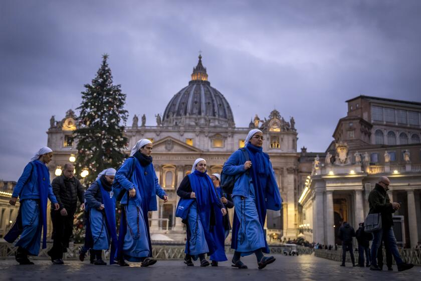 Nuns arrive at dawn to view the body of Pope Emeritus Benedict XVI as it lies in state in St. Peter's Basilica at the Vatican, Tuesday, Jan. 3, 2023. The Vatican announced that Pope Benedict died on Dec. 31, 2022, aged 95, and that his funeral will be held on Thursday, Jan. 5, 2023. (AP Photo/Ben Curtis)