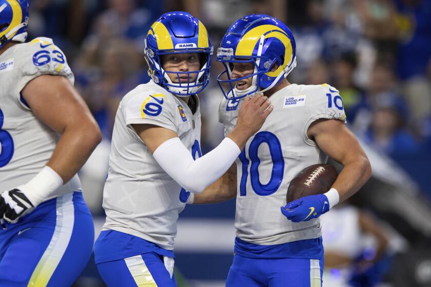 Rams receiver Cooper Kupp (10) and quarterback Matthew Stafford celebrate a touchdown at Indianapolis on Sept. 19, 2021.