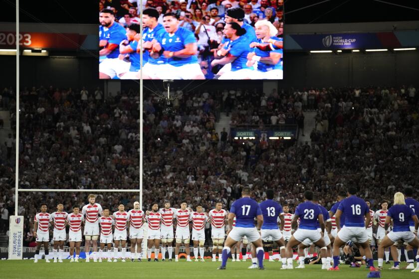 Japan's players watch on as Samoa's players perform their traditional Haka ahead of the Rugby World Cup Pool D match between Japan and Samoa, at the Stadium de Toulouse in Toulouse, France, Thursday, Sept. 28, 2023. (AP Photo/Christophe Ena)