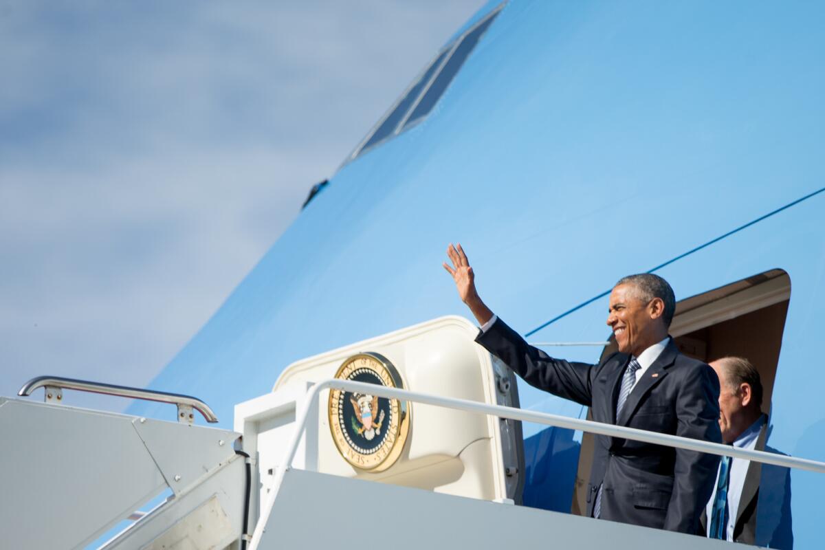 President Obama, accompanied by Alaska Gov. Bill Walker, steps off Air Force One after arriving at Joint Base Elmendorf-Richardson in Anchorage.