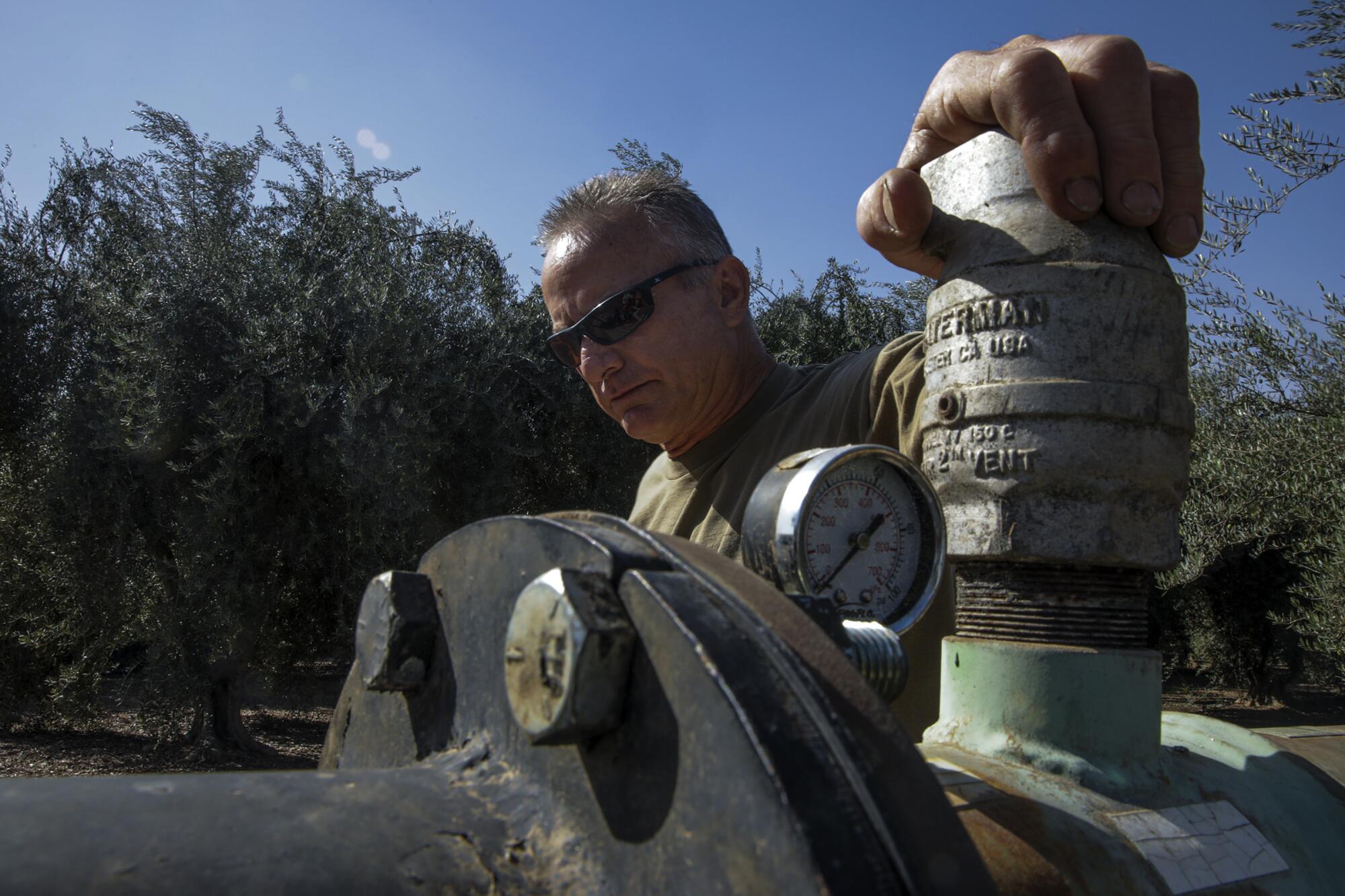 Craig Branco owns an olive orchard and a rental home near Visalia where two wells went dry in 2021. 