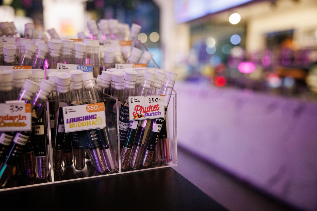 Tubes of pre-rolled joints are displayed for sale in a store