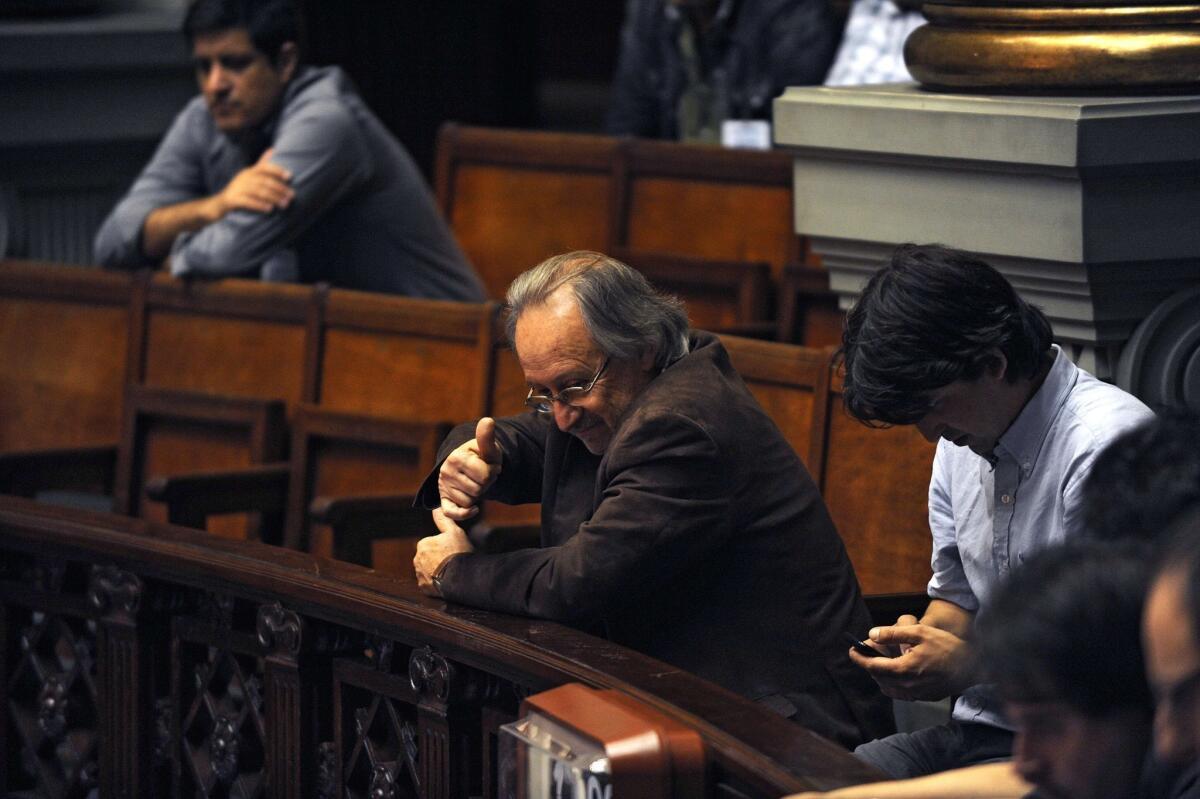 Julio Calzada, head of the Uruguayan government's National Drugs Committee, gives the thumbs up during parliamentary debate Tuesday on a bill that legalizes the growth, sale and use of marijuana and puts the industry under government control and regulation.