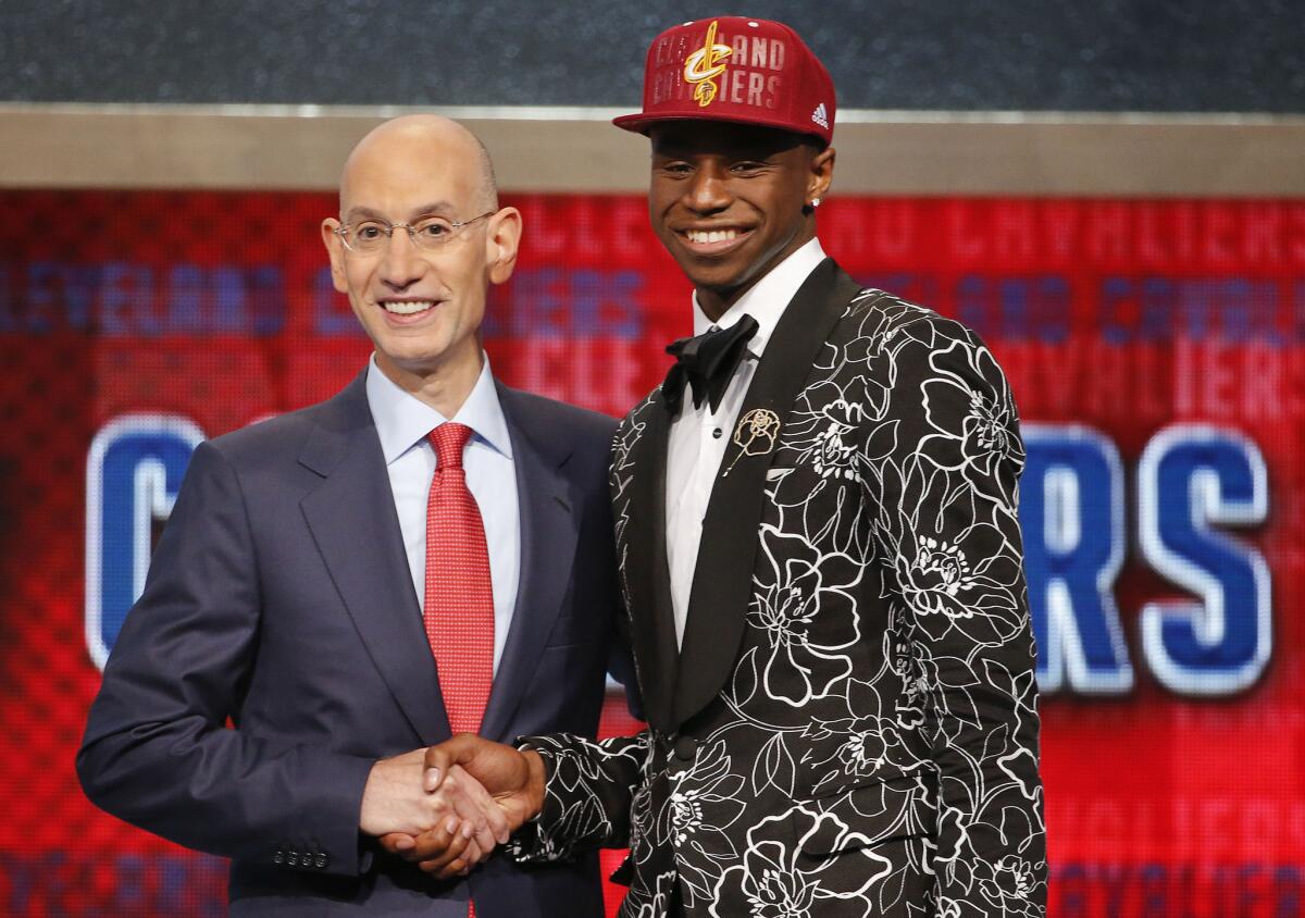 NBA Commissioner Adam Silver, left, congratulates Andrew Wiggins of Kansas who was selected by the Cleveland Cavaliers as the number one pick in the 2014 NBA draft.