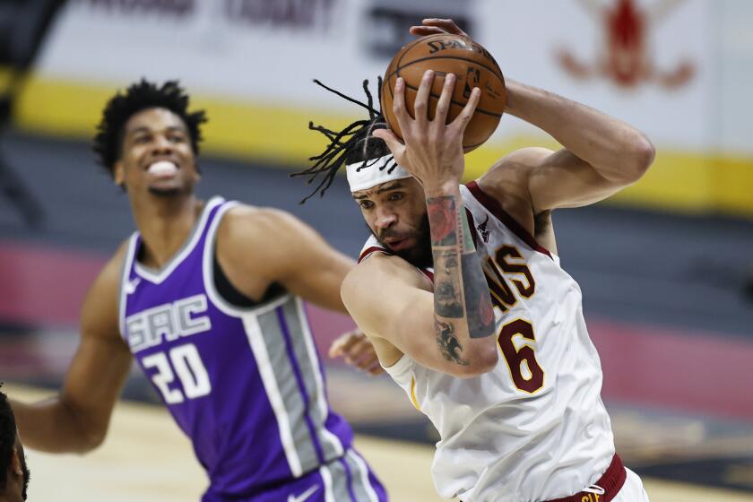 Cleveland Cavaliers' JaVale McGee (6) grabs a rebound next to Sacramento Kings' Hassan Whiteside (20) during the second half of an NBA basketball game Monday, March 22, 2021, in Cleveland. The Kings won 119-105. (AP Photo/Ron Schwane)