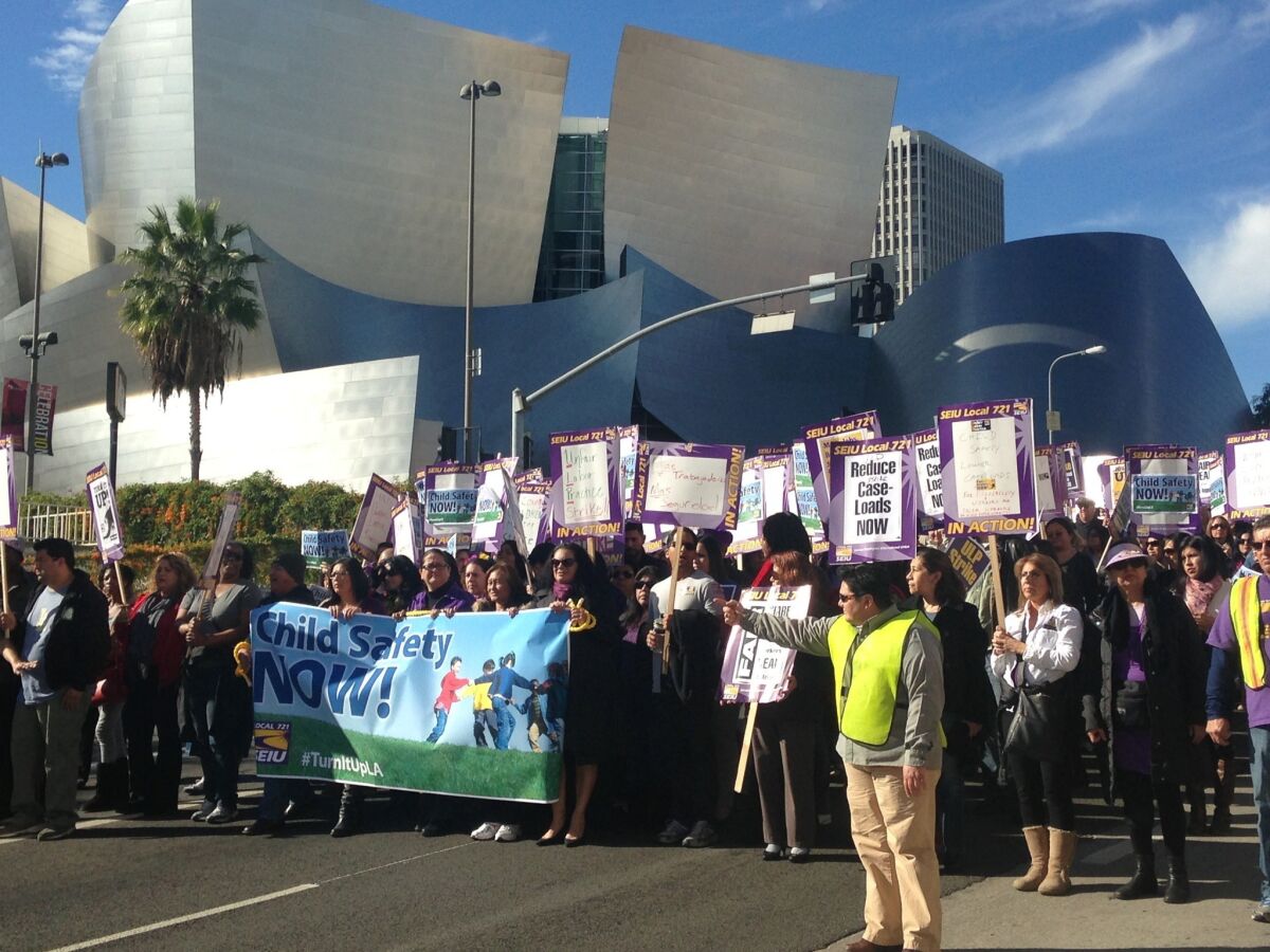 County workers represented by Service Employeees International Union Local 721 protested in downtown Los Angeles on Tuesday. Social workers are on strike seeking reduced caseloads.