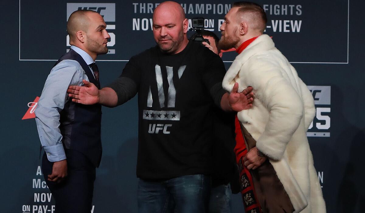 UFC president Dana White seperates Eddie Alvarez and Conor McGregor during the UFC 205 press conference Thursday.