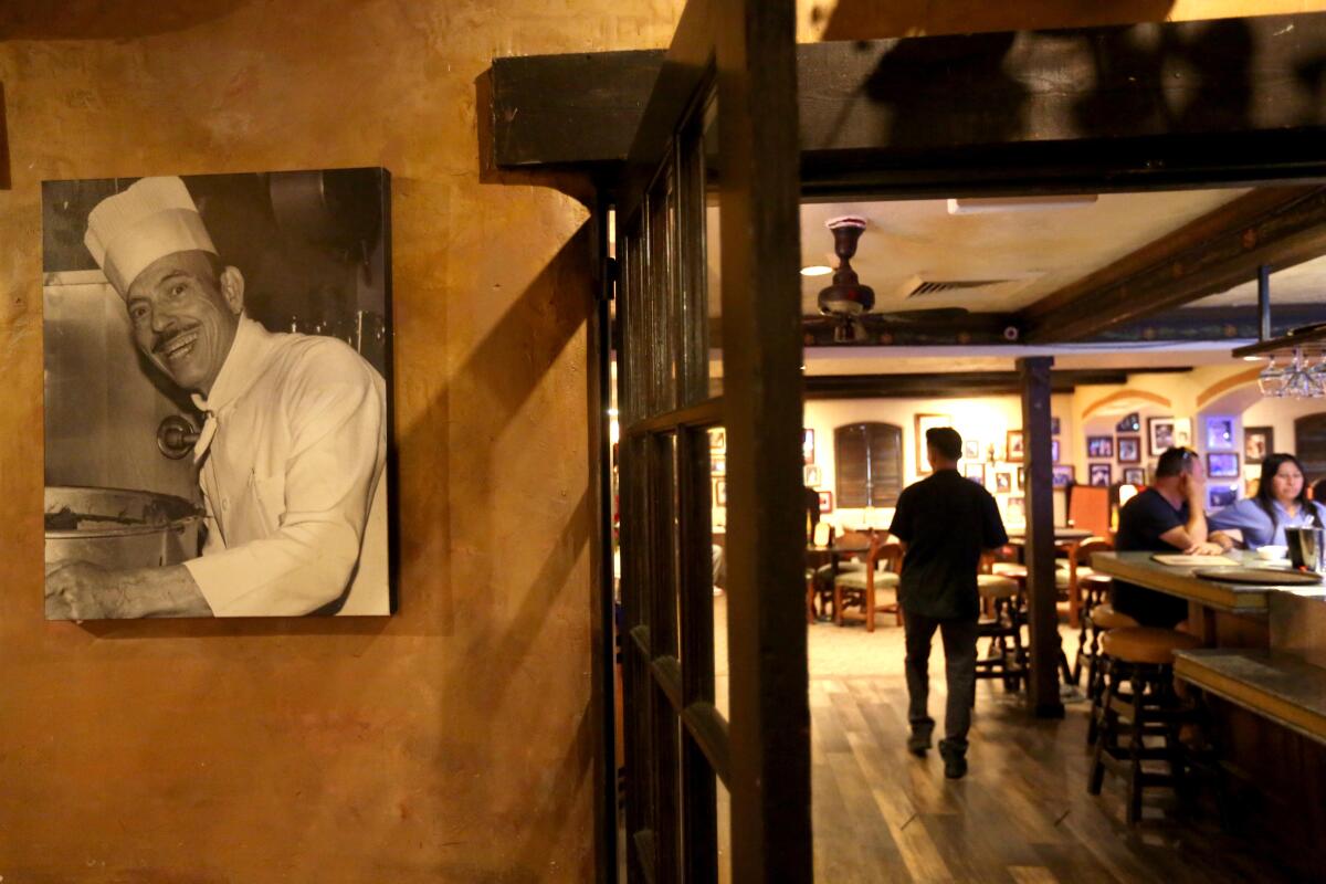 A waiter makes his way into the main dining area at El Cholo The Original Restaurant in Los Angeles.