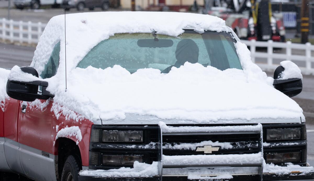 A pickup truck covered in snow
