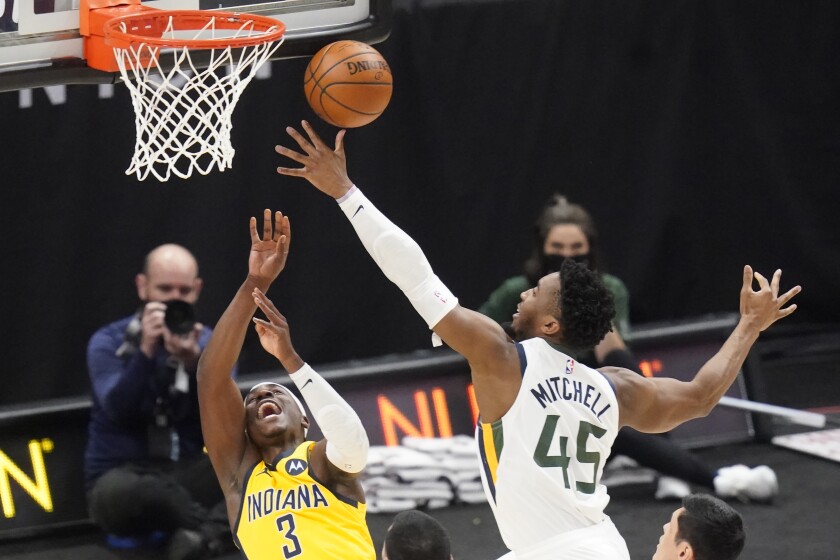 Utah Jazz guard Donovan Mitchell (45) defends against Indiana Pacers guard Aaron Holiday (3) in the first half of an NBA basketball game Friday, April 16, 2021, in Salt Lake City. (AP Photo/Rick Bowmer)