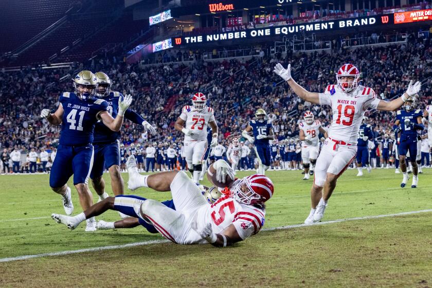 Mater Dei lineman Tomu Topui scores on a 15 yard pass against St John Bosco.