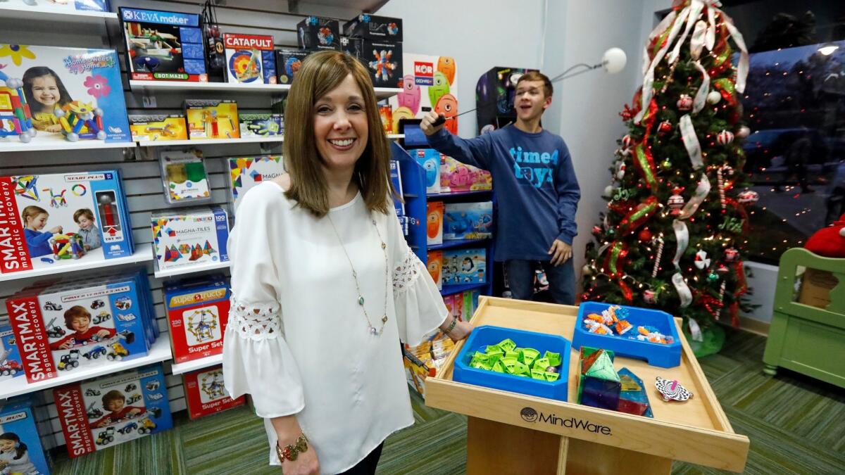 Bethany Mathis, shown with son Hayden, 14, owns Time 4 Toys in Flowood, Miss., where kids can test toys before they're purchased.