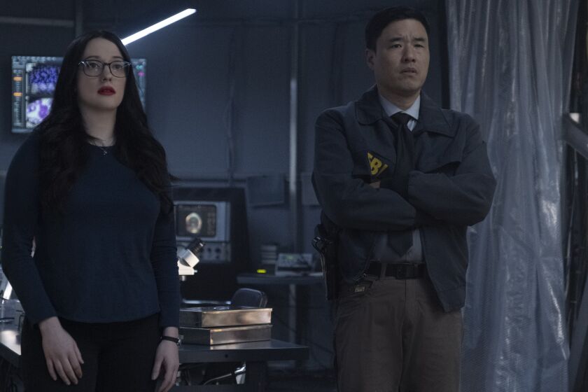 (L-R): Kat Dennings as Darcy Lewis and Randall Park as Jimmy Woo in Marvel Studios' WANDAVISION