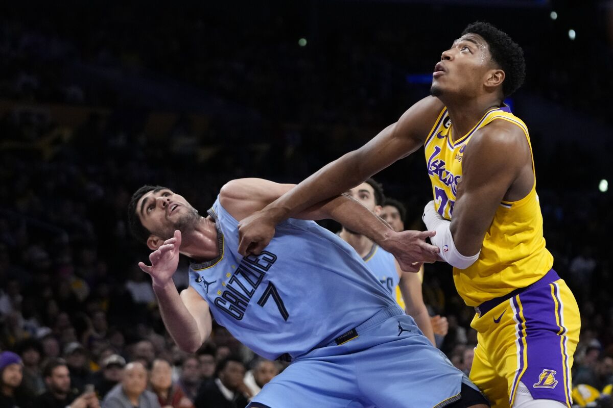 Rui Hachimura grapples for the rebound with Santi Aldama.