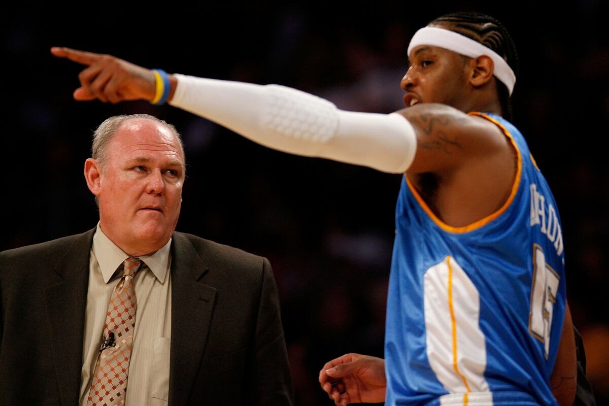 George Karl, left, talks with Carmelo Anthony during a Denver Nuggets playoff game in 2008.