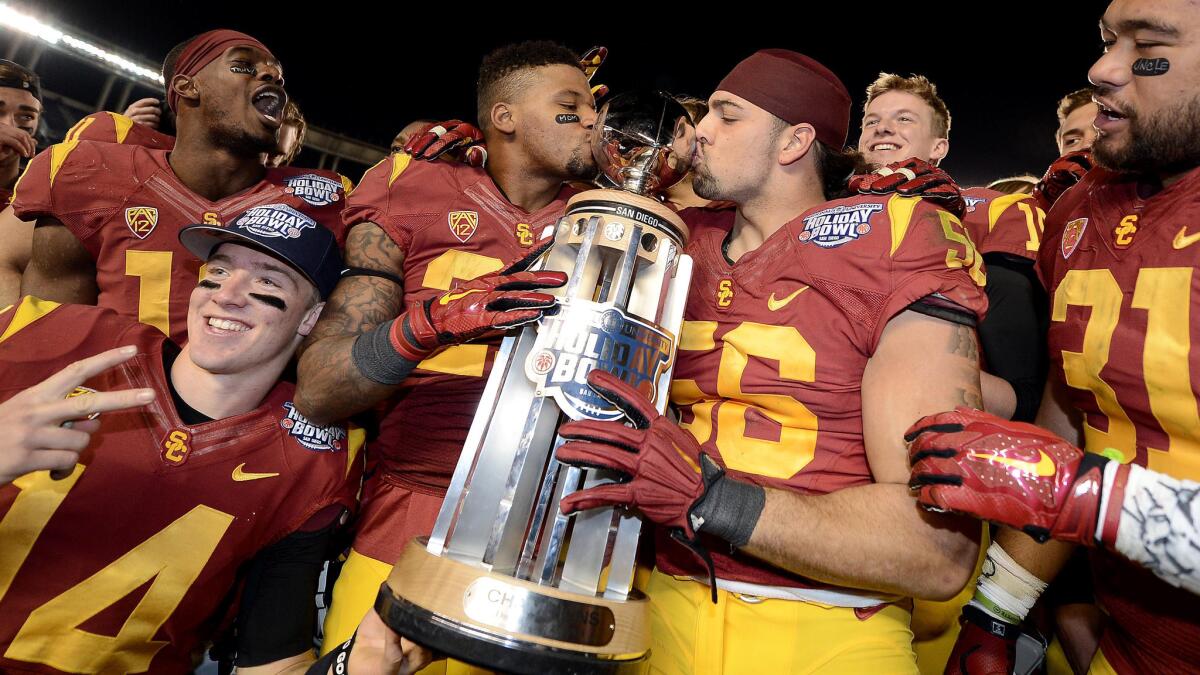 USC football players celebrate their Holiday Bowl victory over Nebraska at Qualcomm Stadium in San Diego on Dec. 27.