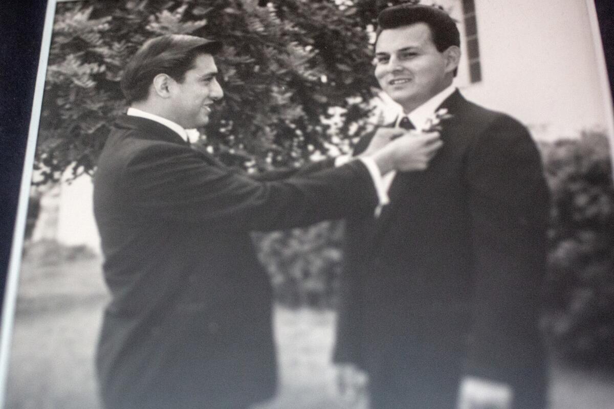 A framed photograph of Raul Guerra, left, as the best man for Ruben Valencia, right, on his wedding day.