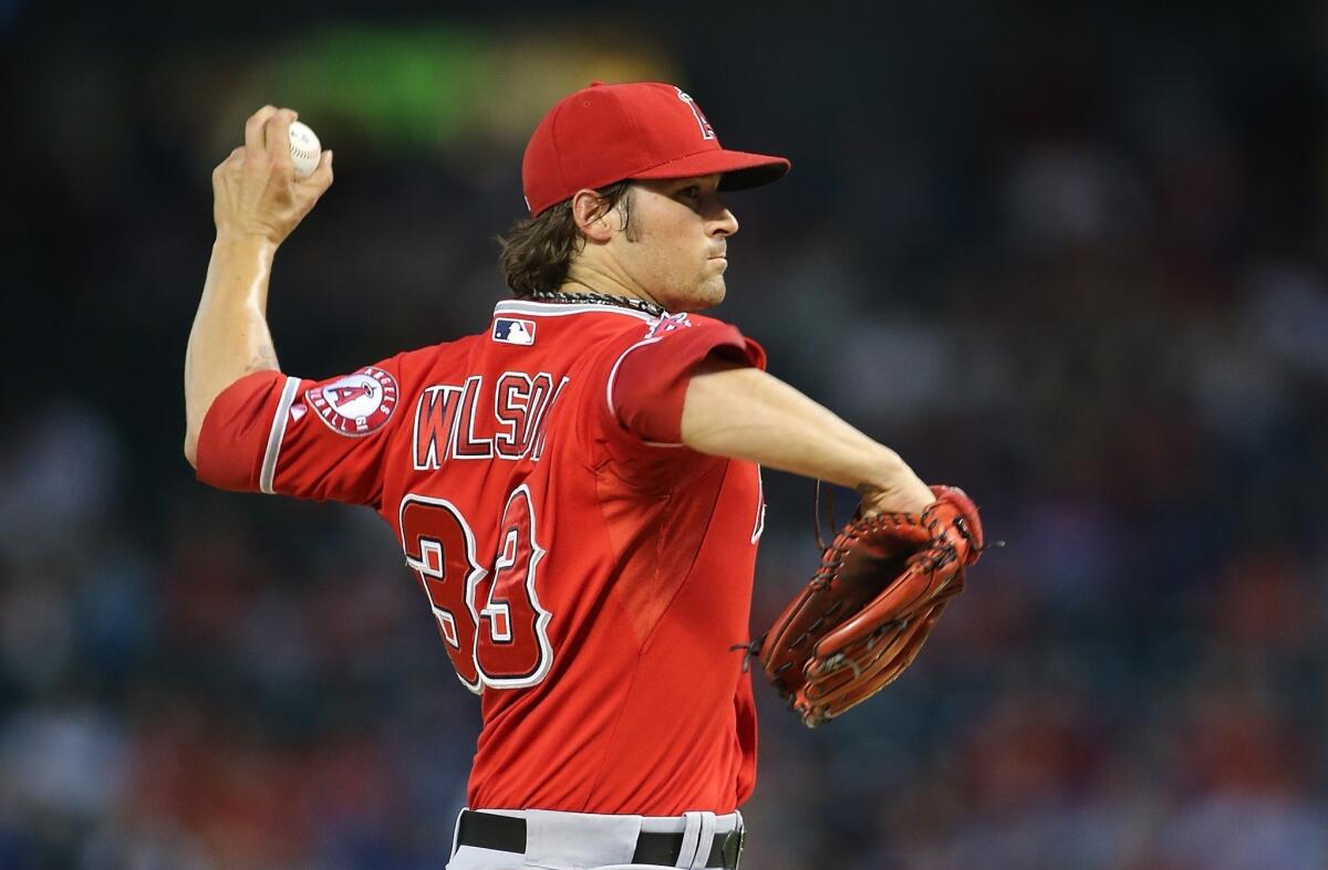 Angels starting pitcher C.J. Wilson walked four in six innings, threw three wild pitches and hit two batters in a 5-3 loss to the Texas Rangers on Friday night.