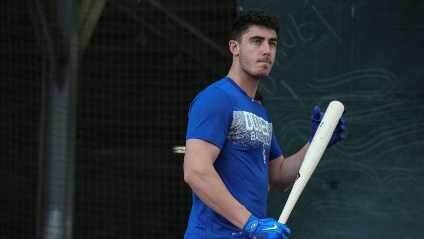 Cody Bellinger waits his turn in the batting cage at spring training.