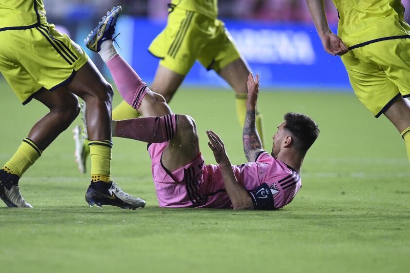 Inter Miami forward Lionel Messi is tripped by the Nashville SC defense during the first half of a CONCACAF Champions Cup soccer match, Wednesday, March 13, 2024, in Fort Lauderdale, Fla. (AP Photo/Michael Laughlin)