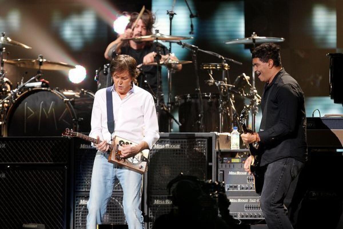 Paul McCartney, left, jams with drummer Dave Grohl and guitarist Pat Smear at "121212: The Concert for Sandy Relief" benefit in New York.