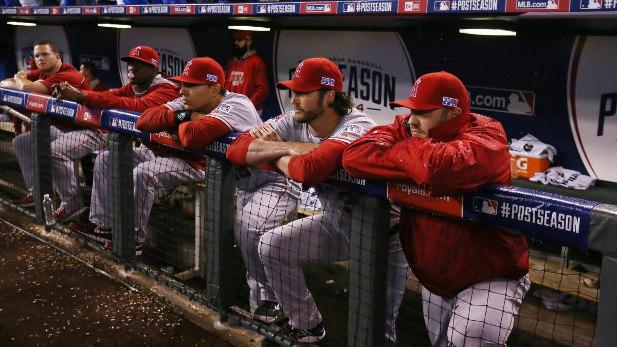 Angels players watch from the dugout during the team's season-ending loss to the Kansas City Royals in Game 3 of the American League division series on Sunday.