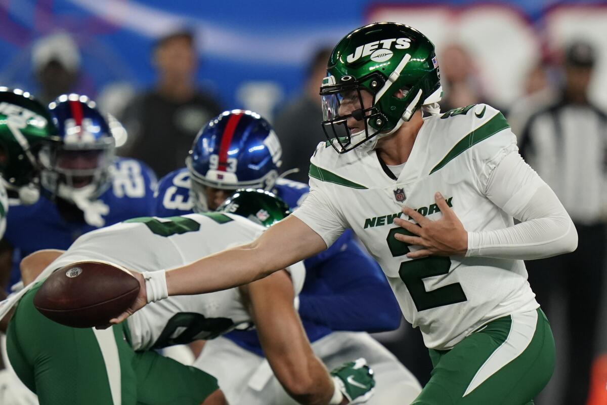 New York Jets quarterback Zach Wilson (2) looks to hand off the ball in the first half of an NFL preseason football game against the New York Giants, Saturday, Aug. 14, 2021, in East Rutherford, N.J. (AP Photo/Frank Franklin II)