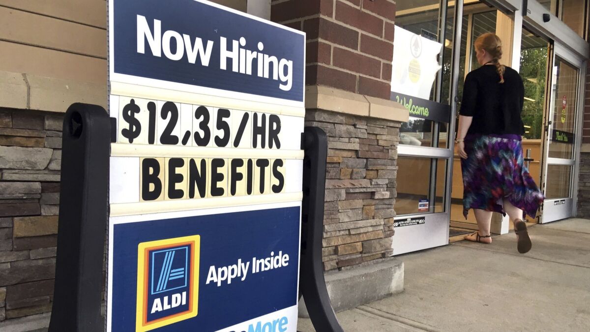 A sign outside a business in Salem, N.H., looks for job applicants.
