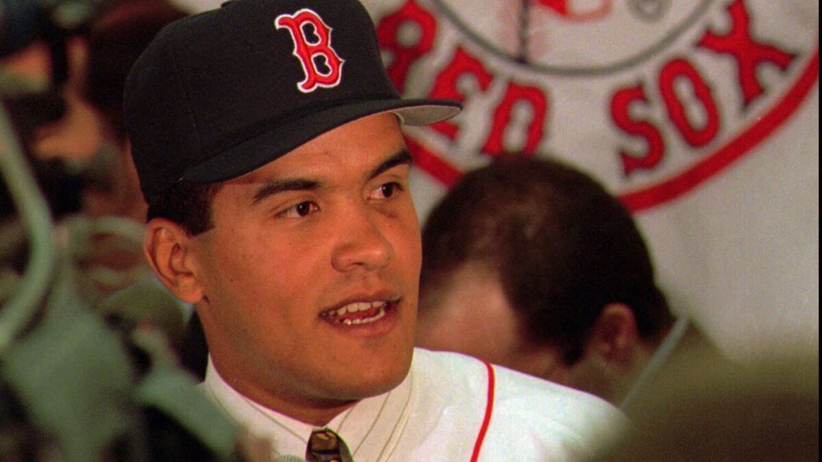 Wil Cordero speaks to reporters following a news conference in 1996. The Boston Red Sox suspended Cordero in 1997 after he was arrested and charged with assaulting his wife.