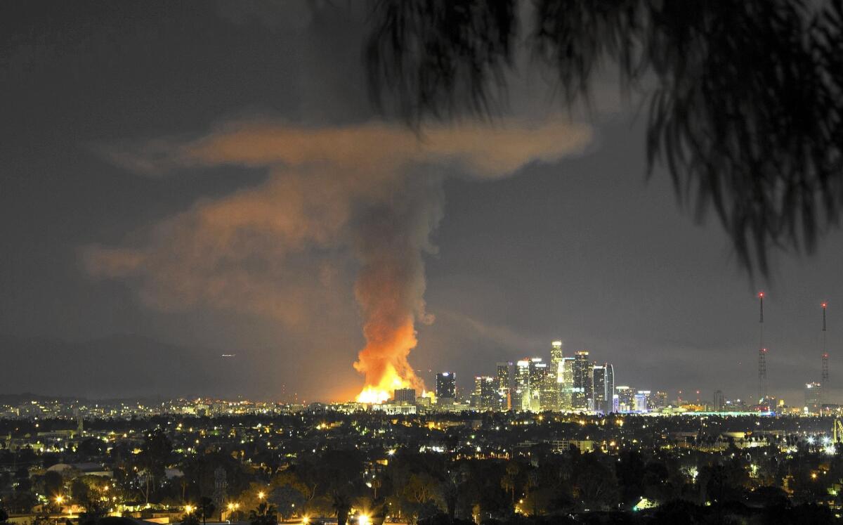 Flames leap seven stories into the air as a massive downtown L.A. apartment complex being framed was destroyed by fire.
