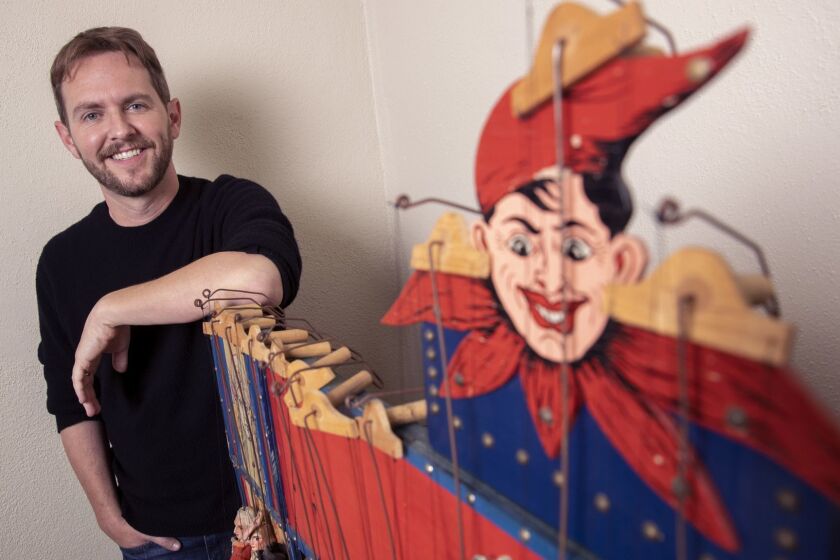 WESTWOOD, CALIF. -- THURSDAY, AUGUST 30, 2018: Matt Shakman, the new artistic director of the Geffen Playhouse, stands with a vintage puppet theatre in his office in Westwood, Calif., on Aug. 30, 2018. (Brian van der Brug / Los Angeles Times)